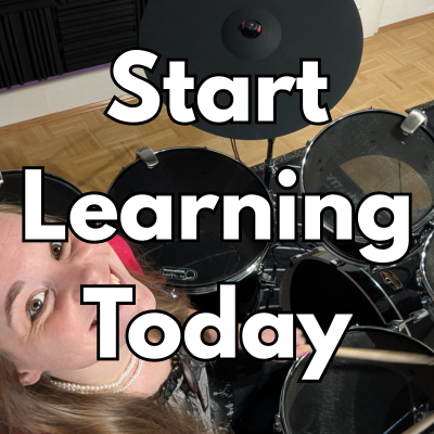 Female drummer smiling at camera 